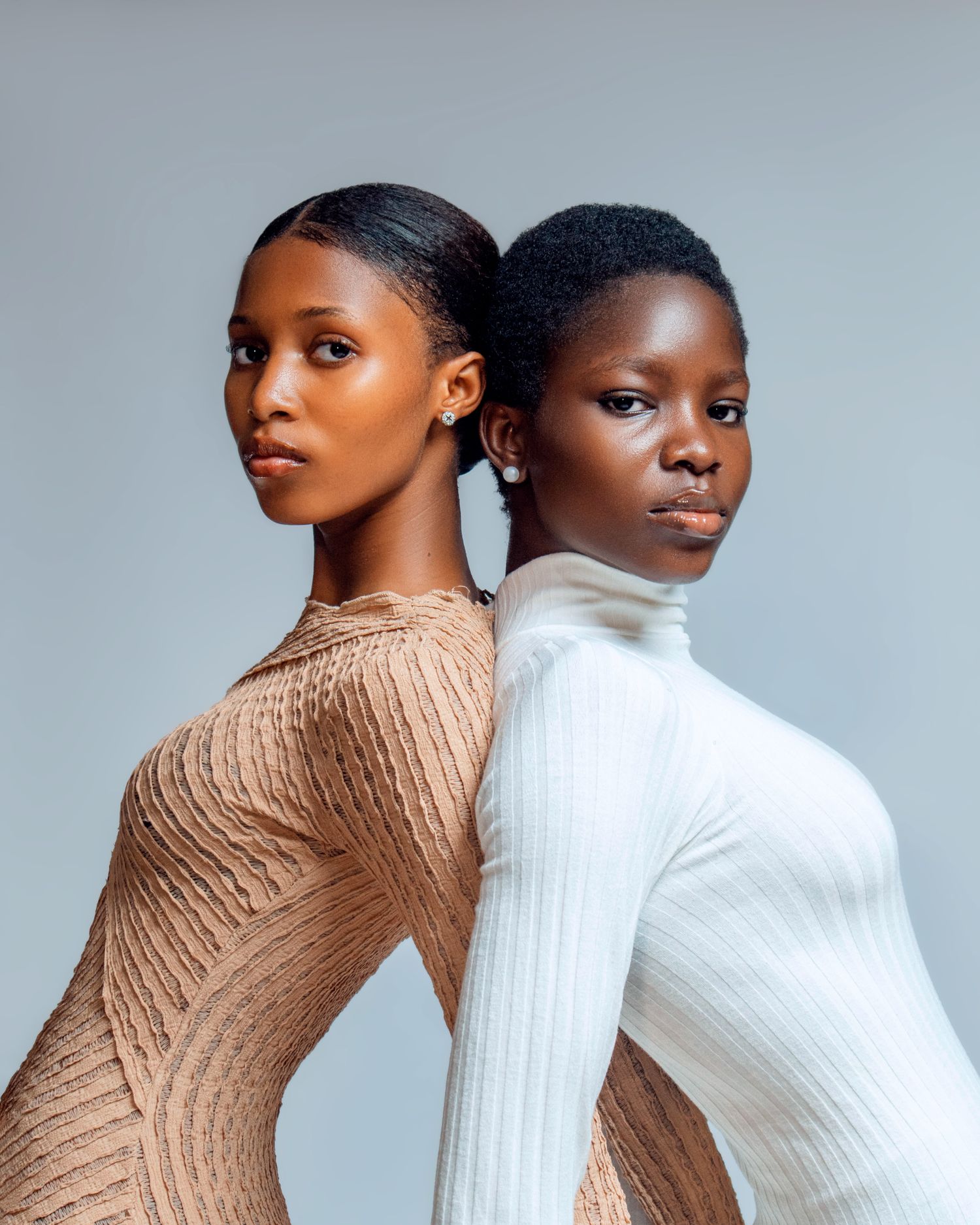 Two women in modern Nigerian fashion