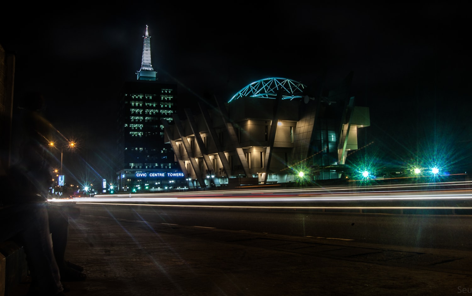 Lagos at night, light trails running past the towers on Victoria Island